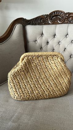 a wicker basket sitting on top of a couch next to a wooden headboard