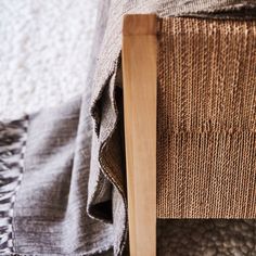 a close up of a bed with a wooden headboard and foot board on it