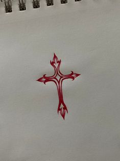 a cross drawn on paper with red ink