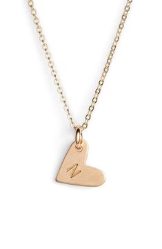 From humble beginnings to a fully staffed warehouse in Oregon, Nashelle remains true to its original purpose-handmade jewelry crafted with love and intention. The heart initial necklace is no different-with a hand-stamped pendant anchored by a single ring, it makes for a perfect layering piece. Style Name:Nashelle 14K-Gold Fill Initial Mini Heart Pendant Necklace. Style Number: 5143637. Available in stores. Everyday Initial Pendant Necklace With Heart Charm, Personalized Heart Necklace For Everyday Wear, Personalized Heart Pendant Initial Necklace For Everyday, Everyday Heart Initial Pendant Necklace For Mother's Day, Minimalist Yellow Gold Initial Necklace With Heart Charm, Everyday Heart Pendant Necklace With Initials, Minimalist Heart Charm Jewelry For Everyday, Minimalist Everyday Jewelry With Heart Charm, Personalized Gold Heart Necklace For Everyday