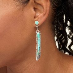 Chaco Canyon Sterling Silver Campitos Turquoise Feather Drop Earrings Generations of Navajo artistry inspire the iconic feather motif that makes this handcrafted earring a spirited tribute to Navajo design, and a distinctive find for your wardrobe.        Each approx. 3-1/4"L x 5/16"W     Stamped .925 sterling silver; polished, oxidized finish      Pierced with bullet-disc backs     Bezel settings; ribbed, feather-inspired texturing; handcrafted     Designed and Crafted in the USA   Stone Information      All sizes and weights approximate     Stabilized Campitos Turquoise: Stabilized Campitos Turquoise: Round (5mm), rectangular (1x3-3x2mm, 5x2-8x3mm) Turquoise Bohemian Jewelry With Feathers, Bohemian Turquoise Jewelry With Feathers, Chaco Canyon, Southwest Jewelry, Color Bands, Jewelry Show, Handcrafted Earrings, Bezel Setting, Handcrafted Jewelry