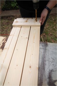 a person using a drill to build a piece of wood