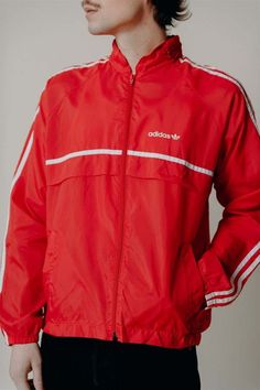 Red adidas track jacket    made in usa    100% nylon    measurements:    22.5" armpit to armpit    25" length    condition: some markings on front of left sleeve. Red Nylon Hooded Track Jacket, Urban Style Red Track Jacket For Streetwear, Red Nylon Sporty Track Jacket, Casual University Red Track Jacket For Streetwear, Red Nylon Track Jacket For Streetwear, Red Nylon Streetwear Windbreaker, Red Nylon Sportswear Track Jacket, Red Nylon Windbreaker For Streetwear, Red Nylon Track Jacket