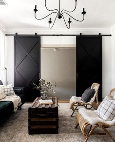 a living room filled with furniture and a chandelier