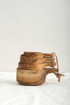 three wooden bowls with measuring tape on them