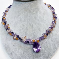 "DESCRIPTION: Thank you for coming in! A breath-takingly beautiful necklace made of an assortment of natural gemstones! You can find Iolite, Amethyst, sunstone and peach moonstone in this one necklace! Premium quality gemstones finished with gold filled headpins and 18k solid yellow gold clasp! 17\" gorgeous necklace, 186.9 carats! You'll get the necklace you see! SIZE: 14.7mmx23.5mm center stone. GRADE: Transparent COLOR: Multi" Amethyst Briolette Necklace With Gemstone Accents, Briolette Amethyst Natural Stone Gemstones, Teardrop Amethyst Necklaces With Gemstone Accents, Amethyst Briolette Necklace For Jewelry Making, Natural Teardrop Amethyst Gemstones, Purple Briolette Gemstone Crystal Necklace, Teardrop Amethyst Gemstone Beads Necklaces, Amethyst Multi-stone Briolette Gemstones, Amethyst Briolette Multi-stone Gemstones