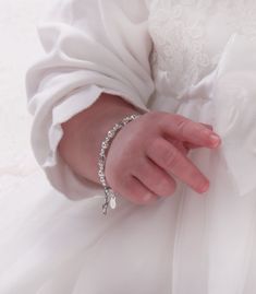 "This precious baptism and christening bracelet is made of sterling silver and high-end simulated pearls with sparkling high-end crystals and accented with a sweet dainty sterling silver cross charm for babies and infants (0-12 months adjustable). Celebrate these cherished moments with this keepsake she will treasure forever! Bracelet measures 4 - 4.5 inches. Made in the USA Make is extra special by adding a personalized initial charm so it's unique just for her. Add a silver-plated jewelry box Toddler Jewelry, Bracelet With Pearls, Forever Bracelet, Silver Cross Bracelet, Baby Dedication, Baptism Girl, Christening Gifts, Cross Bracelet, Gift For Girls