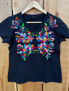 "Beautiful! Hand embroidered t- shirts ! One of a kind embroidered t- shirts ! Comfortable, fresh , one if a kind t- shirts ! Fabric : cotton. Care : hand wash/hang to dry/ low iron / NO BLEACH. MEASUREMENTS: Length: 24.5 Armpit to armpit: 20\"	is_active	20458565	Apparel & Accessories > Clothing > Shirts & Tops	https://www.etsy.com/listing/984295898/size-medium-6us-hand-embroidered-t-shirt	clothing > womens_clothing > tops_and_tees > tshirts > graphic_tees	https://i.ets Multicolor Embroidered Cotton Shirt, Black Embroidered T-shirt For Summer, Summer T-shirt With Multicolor Embroidery And Short Sleeves, Multicolor Floral Embroidery T-shirt For Summer, Summer T-shirt With Multicolor Embroidery, Summer Multicolor Embroidered Short Sleeve T-shirt, Summer Cotton Tops With Machine Embroidery, Bohemian T-shirt With Floral Embroidery And Short Sleeves, Bohemian Cotton Tops With Machine Embroidery