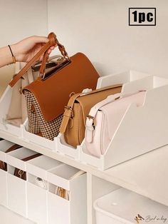 a white shelf holding purses and handbags in it's storage bins