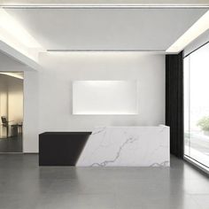 an empty room with white walls and marble counter