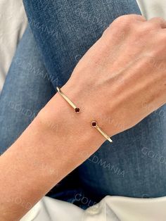 All Our Bracelets Are Made Of REAL 14K GOLD  14K Yellow Gold 3mm Round Garnet Open Cuff Bangle Bracelet, Real Gold Bangle, Women  Shop our 14K Bracelets https://www.etsy.com/shop/GOLDMANIA?ref=seller-platform-mcnav§ion_id=26925987  Shop On Sale items https://www.etsy.com/shop/GOLDMANIA?ref=seller-platform-mcnav§ion_id=1  Metal: 14K Yellow Gold   Width: 2 MM  Length: 7 IN  Closure:  Weight: 3.30 Gram   Gemstone size: 3mm Also available with Peridot, Citrine, Blue Topaz And Amethyst   SHIPPED FROM Yellow Gold Open Cuff Jewelry Gift, Yellow Gold Open Cuff Bangle For Gift, Yellow Gold Open Cuff Bangle As Gift, Classic Gold Bangle With Gemstone, Elegant Gold Bangle With Birthstone, Gold Bangle With Birthstone, Gold Bangle Bracelet With Birthstone, Cuff Bangle Bracelet, Gold Bangle