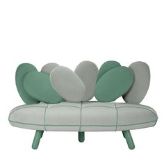 a green and white couch with four hearts on it's backrest, sitting in front of a white background