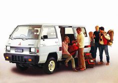 a group of people standing next to a white van