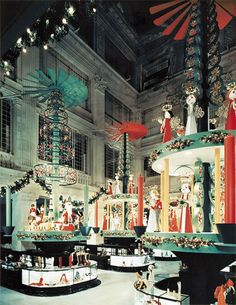 an elaborately decorated room with orange and white decorations on the walls, chandeliers and windows