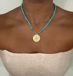 𝐄𝐗𝐐𝐔𝐈𝐒𝐈𝐓𝐄 𝐓𝐔𝐑𝐐𝐔𝐎𝐈𝐒𝐄: Elevate your style with a turquoise necklace featuring carefully selected turquoise beads and a stunning coin pendant 𝟏𝟒𝐊 𝐆𝐎𝐋𝐃 𝐅𝐈𝐋𝐋𝐄𝐃: Indulge in the opulence of a celestial necklace adorned with high-quality 14K gold filled accents for a timeless and elegant touch 𝐆𝐋𝐎𝐑𝐈𝐎𝐔𝐒 𝐅𝐔𝐒𝐈𝐎𝐍: Unleash the allure of gemstones seamlessly combined with gold balls, creating a magnificent and radiant accessory that captivates attention 𝐓𝐈𝐌𝐄𝐋𝐄𝐒𝐒 𝐄𝐋𝐄𝐆𝐀𝐍𝐂𝐄: Experience enduring beauty with a handcrafted binding ensuring both durability and a sophisticated aesthetic, making it a cherished piece for years 𝐄𝐅𝐅𝐎𝐑𝐓𝐋𝐄𝐒𝐒 𝐖𝐄𝐀𝐑𝐈𝐍𝐆: Enjoy the simplicity of wearing this coin necklace - a secure and easy-to-fasten design tha Beaded Coin Necklace, Turquoise Necklaces, Contemporary Jewelry Design, Sophisticated Aesthetic, Celestial Necklace, Turquoise Bead Necklaces, Necklaces Jewelry, Coin Necklace, Coin Pendant