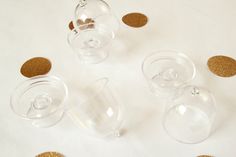 three wine glasses with corks on the side