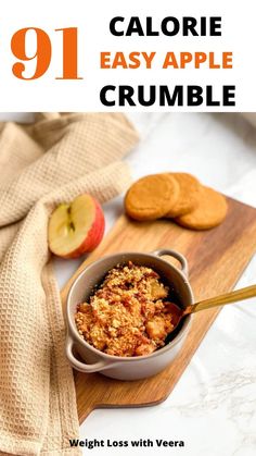 an apple crumble in a bowl on a cutting board next to cookies and apples