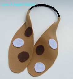 a pair of brown and white slippers with polka dots on the bottom one is made out of felt