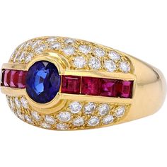 Marvel at the myriad of magnificence with this stunning 18K Yellow Gold Sapphire & Ruby Ring from our exquisite collection. Crafted to capture the essence of timeless elegance, this ring features a captivating Sapphire as its main stone, boasting a total carat weight of 1.58 Carats. Complementing the allure are dazzling Diamonds with a total weight of 0.73 Carats, adding a touch of brilliance to this already mesmerizing piece.The rich, warm tones of 18K Yellow Gold perfectly enhance the vivid colors of the gemstones, creating a harmonious and luxurious aesthetic. Whether worn as a symbol of your personal style or as a cherished heirloom, this ring exudes sophistication and grace.Indulge in the allure of this Estate Jewelry piece and embrace the enchanting beauty that transcends time and tr Luxury Oval Multi-stone Diamond Ring, Luxury Oval Sapphire Ring With Pave Setting, Luxury Ruby Ring With Diamond Accents, Luxury Brilliant Cut Sapphire Gemstones, Luxury Diamond Ruby Ring, Luxury Ruby Ring With Gemstone Accents, Luxury Ruby Halo Ring, Luxury Ruby Ring With Diamonds, Luxury Multi-stone Sapphire Gemstones