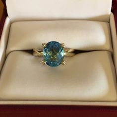 Ladies 10kt Yellow Gold Swiss Blue Topaz And Diamond Ring. Four Small Diamonds Are Set In The Prongs. Blue Swiss Topaz Is A Oval Checkerboard Cut 8 X10. Ring Size Is 5 1/4. Used But In New Condition. Topaz And Diamond Ring, Ring Color, Swiss Blue Topaz, Gold Yellow, Womens Jewelry Rings, Blue Gold, Blue Topaz, Topaz, Diamond Ring