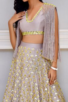 Mauve lehenga with mirror, sequin and cutdana embroidered motifs. Paired with mirror embroidered and cutdana tassel crop top.
Component: 2
Embroidered
Neckline: V neck
Sleeve Length: Sleeveless
Fabric: Chanderi Silk
Color: Purple
Mirror work
Tassel detail - Aza Fashions Bollywood Style Dola Silk Choli With Sequins, Bollywood Style Sequined Dola Silk Choli, Traditional Drape Sequined Choli In Chinon, Festive Dola Silk Choli With Sequins, Traditional Drape Choli With Sequins In Dola Silk, Dola Silk Choli With Sequins For Festivals, Anarkali Choli With Mirror Work For Party, Sequin Dola Silk Choli For Festivals, Traditional Drape Choli With Sequins And Dola Silk