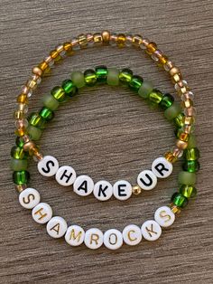 two bracelets that say shake up and shamrock