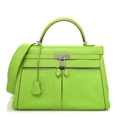 This is an authentic HERMES Swift Lakis Kelly 35 in Granny. This handbag is crafted of calfskin leather in bright green.  The bag features a rolled top handle, palladium silver hardware, an optional shoulder strap, and two front zipper pockets. The top flap opens to a leather interior with zipper and patch pockets. Green Top Handle Bag With Palladium Hardware, Luxury Green Bags With Rolled Handles, Luxury Green Bag With Rolled Handles, Luxury Green Bag With Silver-tone Hardware, Green Leather Bags With Rolled Handles, Bri Aesthetic, Retail Therapy, Bright Green, Leather Interior