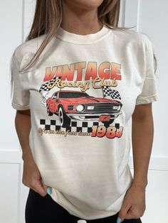 Get in the fast lane with this Vintage Racing Club tee. Featuring a retro car graphic and a checkered print, this tee will have you looking and feeling cool. Made from soft Comfort Colors material, it's perfect for a day out or a night in. Race to get yours today! DETAILS "Vintage Racing Club" graphic tee "Life In The Fast Lane" graphic detail Checkered graphic detail Car graphic on front Vintage/distressed design Comfort Colors branded Soft, comfortable material SIZING Fits true to size Chelsea Vintage Tee Shirts For Women, Retro Tshirt Design Graphics, Race Car Outfits For Women, Car Graphic Tee, Car Outfit, Car Rally, Vintage Graphic Tees, Fits Ideas, Fancy Clothes