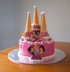 the cake is decorated with princesses castle and ice cream cones on it's top