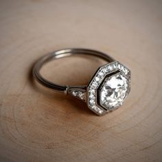 a diamond ring sitting on top of a wooden table