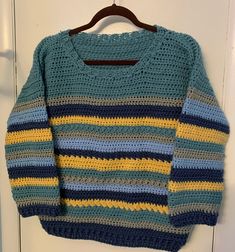 "Pullover crew neck sweater crocheted in sea green, blue, yellow, and gray in a striped pattern of unique \"fancy\" stitches!   Washable (gentle cycle, low heat dry) Measurements: Chest: 38 in Length: 23 in Free Shipping! For more unique handmade sweaters, click here: https://www.etsy.com/shop/ChristianneCrochets?ref=seller-platform-mcnav&section_id=31124024 See all the handmade items available in my shop: https://www.etsy.com/shop/ChristianneCrochets" Green Crochet Knit Sweater, Green Long Sleeve Crochet Sweater, Casual Crochet Crew Neck Sweater, Yellow Crochet Long Sleeve Sweater, Casual Yellow Crochet Sweater, Multicolor Crochet Crew Neck Sweater, Green Crochet Casual Sweater, Green Crochet Sweater Casual Style, Green Casual Crochet Sweater