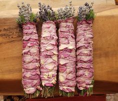 four bundles of purple flowers tied together with twine