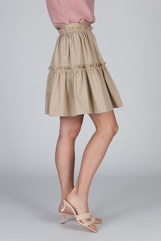 The Elena Skirt has a romantic silhouette and a playful feel. This tiered skirt with a fixed waistband and a concealed back zip closure, is cut from our crisp cotton poplin. It sits high at your waist and features trapunto top stitching to create texture. The gathered fabric allows for subtle volume --twirling will just come natural. Elegant Cotton Skirt With Ruffle Hem, Chic Tiered Voluminous Skirt, Spring Tiered Voluminous Skirt, Chic Voluminous Tiered Skirt, Chic Cotton Mini Skirt With Pleated Hem, Feminine Bottoms With Ruffle Hem And Voluminous Skirt, Cotton Ruffle Mini Skirt For Daywear, Relaxed Tiered Cotton Skirt, Beige Tiered Skirt For Daywear