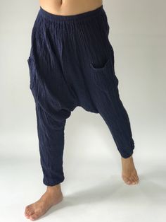 "These super soft rayon baggy unisex harem pants have the \"flow\", perfect of yoga or just a cool strolling. Comfort and character are what these pants are all about. They have the traditional sarong look & feel but a lot more practical when it comes to activity like yoga. As a bonus, they are convertible! Just pull them up and you get yourself a cute jumpsuit in a flash. Together with elastic cuff legs, you can wear them short or long. The pants have smock waist (wide bang elastic) with no Baggy Ankle-length Parachute Pants For Loungewear, Blue Baggy Comfortable Bottoms, Harem Pants With Pockets For Loungewear, Baggy Ankle-length Harem Yoga Pants, Comfortable Baggy Ankle-length Bottoms, Comfortable Baggy Pants For Yoga, Comfortable Loose Bottoms For Yoga, Lagenlook Baggy Pants With Elastic Waistband, Comfortable Baggy Harem Pants For Yoga