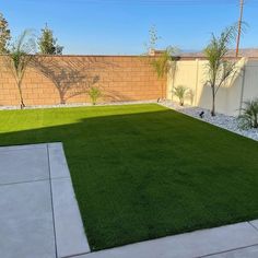 an empty backyard with grass in the middle