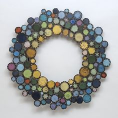 a multicolored brooch sits on a white surface