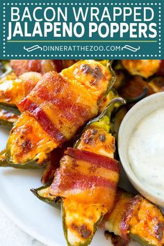 bacon wrapped jalapeno poppers on a plate with ranch dip