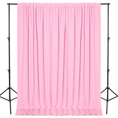 a pink curtain is hanging on a black stand