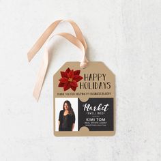 a happy holidays tag with a poinsetti on it