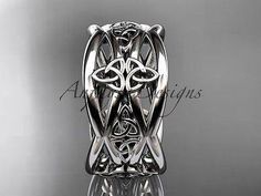 an intricately designed wedding ring with celtic designs on the band and center stone, is shown