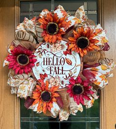 a wreath that says hello fall with sunflowers and burlocks on it