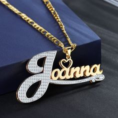 Gold double plated Name Necklace featuring an engraved mini heart charm personalized and custom made with your desired text. Our double plated jewelry is handcrafted with 14K Gold-filled Stainless Steel meaning it is waterproof, hypoallergenic, tarnish-resistant, and everlasting. These are the perfect gifts for the King and Queen in your life. They scream elegance, luxury, and style all while being friendly to your pockets! DETAILS -Waterproof, tarnish-resistant, rust-resistant, hypoallergenic a Elegant Custom Nameplate Chain Necklace, Customizable Gold Chain Necklace For Gifts, Anniversary Nameplate Chain Necklace, Personalized Pendant Chain Necklace For Anniversary, Customized Nameplate Chain Necklace, Figaro Chain Nameplate Jewelry For Anniversary, Anniversary Silver Name Necklace With Figaro Chain, Elegant Gold Chain Necklace With Custom Name, Elegant Nameplate Necklace With Figaro Chain