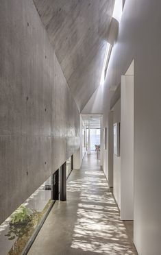 an empty hallway with concrete walls and flooring