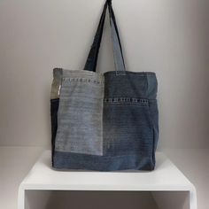 Denim handmade shoulder bag width 39cm length 40cm.  ✨Each bag is a one of a kind as it is made from responsibility sourced denim, and made by hand in our UK based studio. ✨The bags are a square shape and have a panel on the bottom which allows for plenty of storage space. There is also a pocket on each side panel. Our super cute "reworked by Ruthie" label is featured on the side of the bag. ✨The bags are made of a single layer of denim and are finished with an overlocked stitch on the inside of Daily Use Dark Wash Cotton Shoulder Bag, Everyday Dark Wash Cotton Shoulder Bag, Rectangular Denim Blue Shoulder Bag For Everyday Use, Rectangular Denim Blue Cotton Shoulder Bag, Rectangular Dark Wash Shoulder Bag For Everyday Use, Eco-friendly Rectangular Denim Bag, Everyday Rectangular Dark Wash Shoulder Bag, Rectangular Dark Wash Bag For Everyday Use, Blue Recycled Denim Shoulder Bag For Daily Use