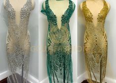 three different dresses on mannequins, one in gold and the other in green