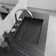 a bathroom sink with black marble counter top and chrome faucet in the middle