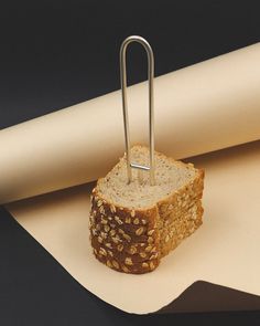 a piece of bread with a paper clip sticking out of it