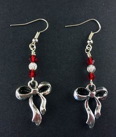 "Antique Silver Ribbon and Bow Earrings with Red and Clear Swarovski Crystals, Festive Holiday Jewelry, Simple Silver and Red Ribbon Earrings Special Holiday Earrings, perfect for gifts and seasonal jewelry Silver Tone Zinc metal alloy(Cadmium Free) Earring Size: ~1.75\" x 3/4\" All Aspen Tree Jewelry is made and stored in a smoke free environment and comes gift wrapped." Metal Crystal Earrings For Valentine's Day Gift, Red Jewelry For Pierced Ears As A Gift, Red Holiday Earrings With Ear Wire, Holiday Red Ear Wire Earrings, Red Handmade Dangle Crystal Earrings, Handmade Red Crystal Dangle Earrings, Red Handmade Crystal Dangle Earrings, Nickel-free Red Crystal Earrings, Red Ear Wire Jewelry For Holidays