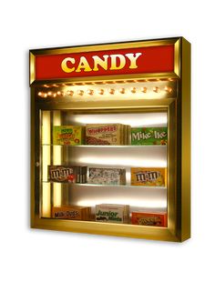 a gold vending machine with candy in it's display case and lights on the front