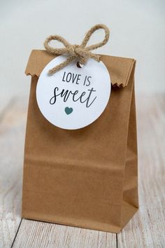 a brown paper bag with a tag that says love is sweet